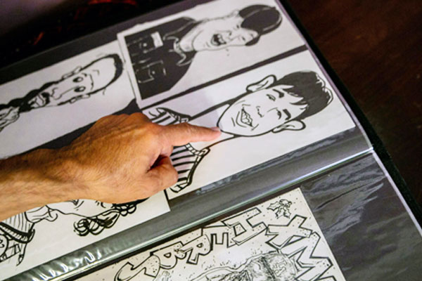 tutor-pointing-to-work-in-an-art-portfolio Art Portfolio Preparation