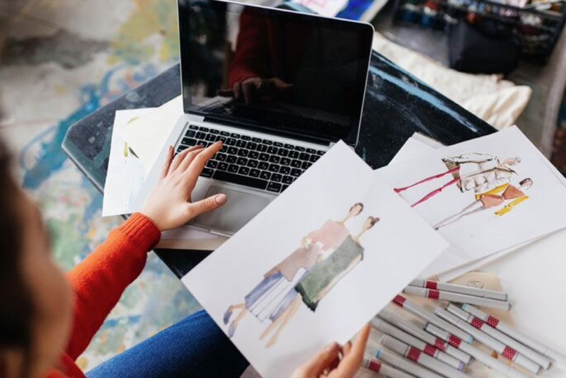 a student who is serious about art works on a fashion design project